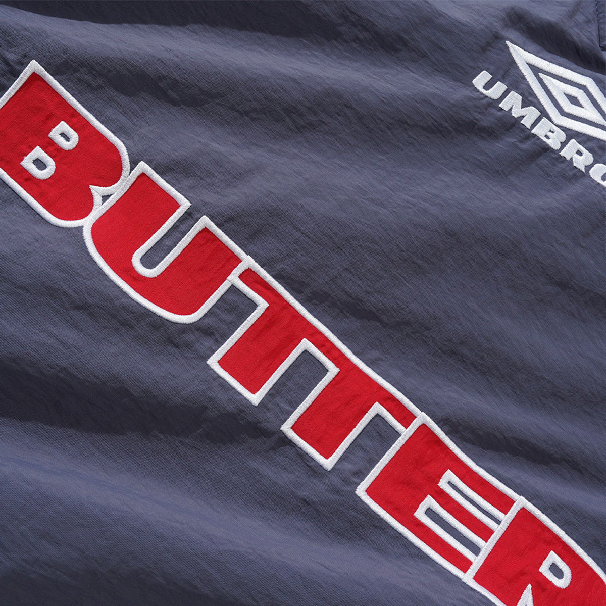 【BUTTER GOODS】Training Pullover - Slate/Navy Butter Goods Men's x Umbro Training Pullover in Slate/Navy